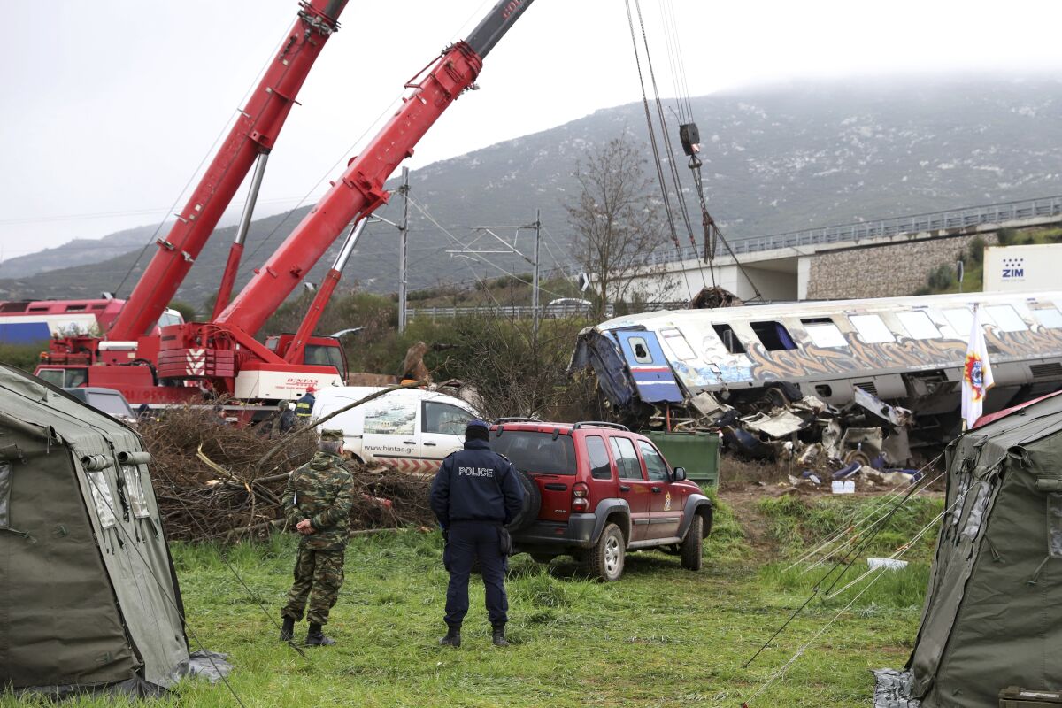 Cranes removing debris from a train collision
