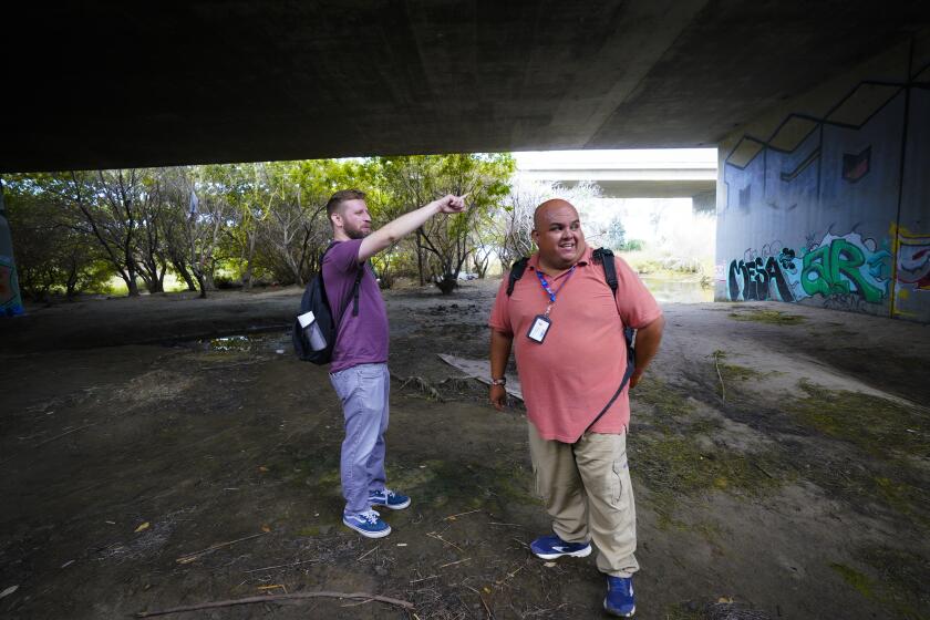 San Diego, CA - July 29: Near the San Diego Riverbed on Friday, July 29, 2022 in San Diego, CA., Alejandro Pulido (r), and Nate Dressel (l), Outreach Specialists from PATH San Diego head out to make contact with clients. (Nelvin C. Cepeda / The San Diego Union-Tribune)