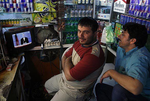 Men in a Kabul juice shop watch the final Afghan presidential debate.