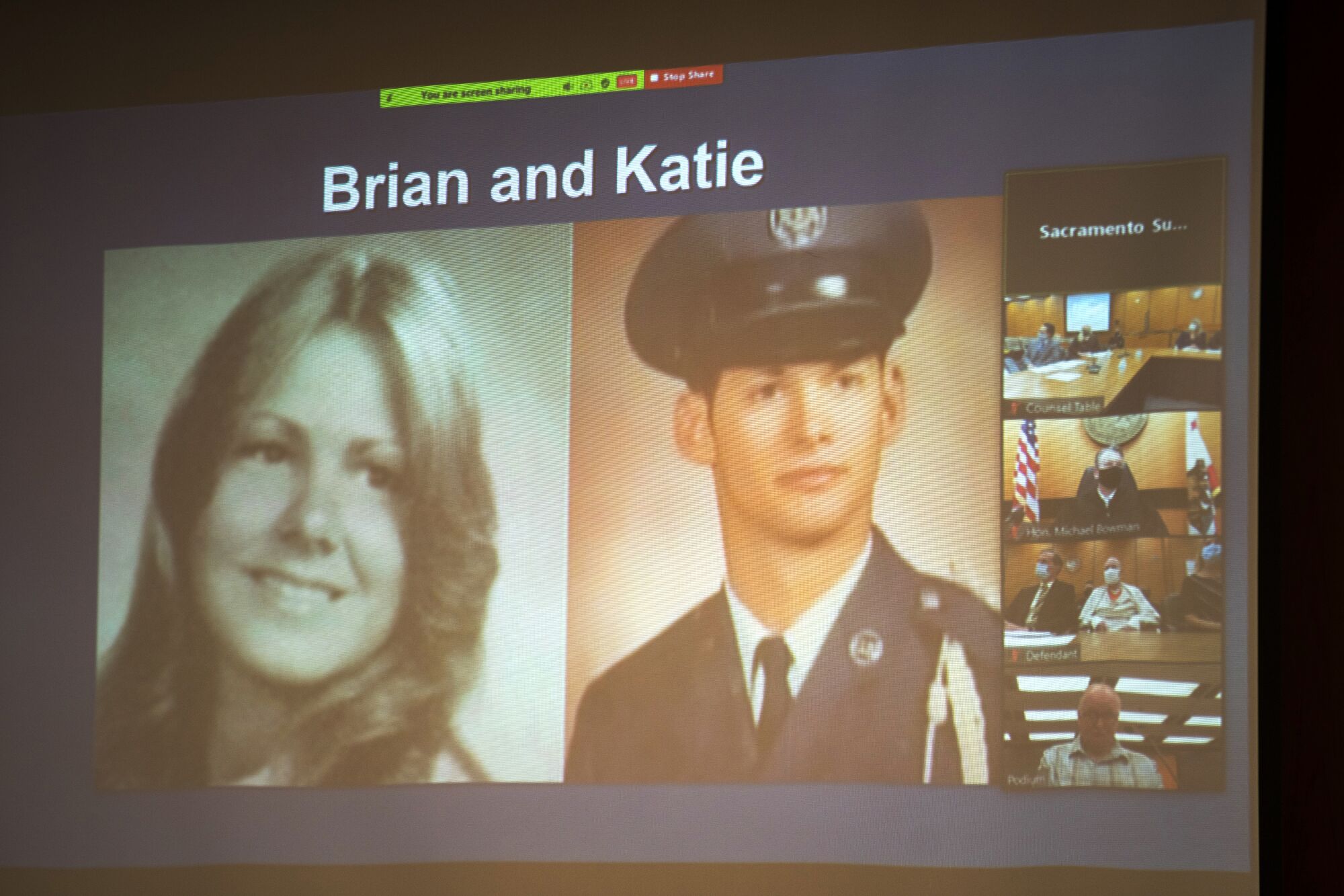 Photos of Katie Maggiore and Brian Maggiore are projected onto a screen