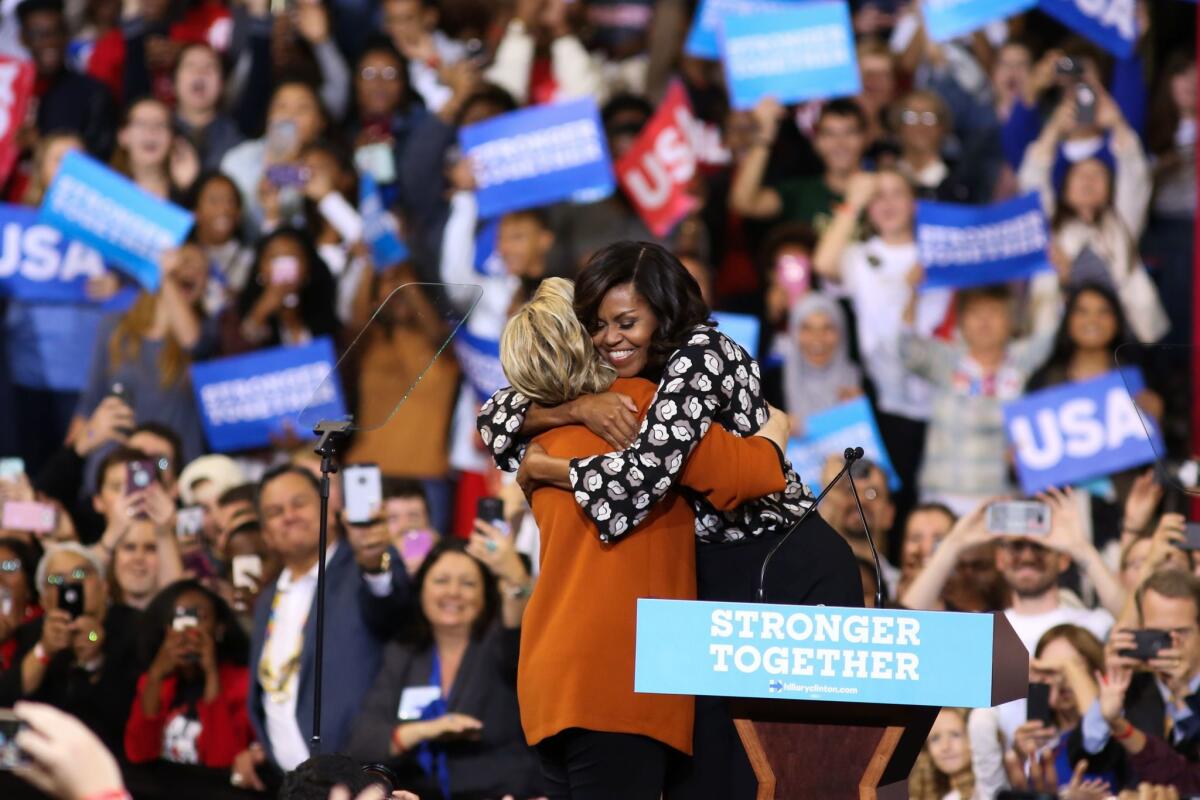 Hillary Clinton and Michelle Obama embrace before they address the crowd at a campaign stop in Winston-Salem, N.C., on Oct. 27, 2016.