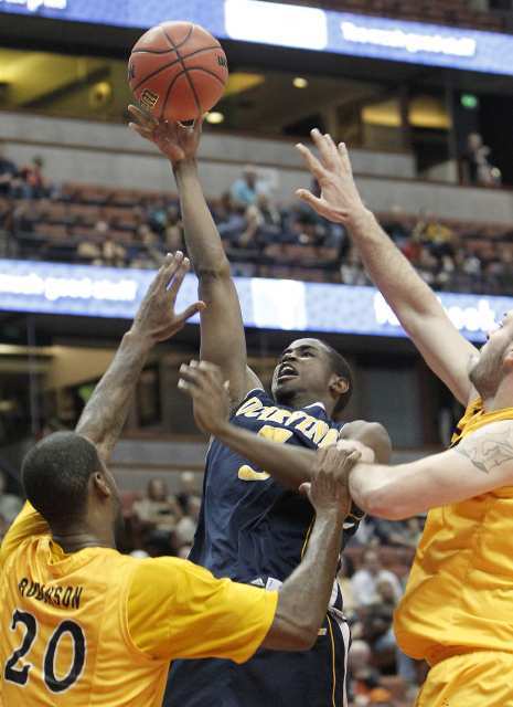 UC Irvine's Chris McNealy, center, attempts to score between two Long Beach State defenders.