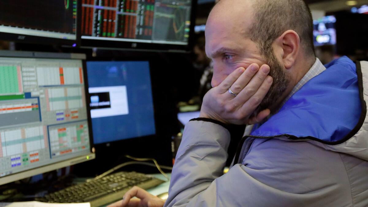 Specialist James Denaro works on the floor of the New York Stock Exchange.