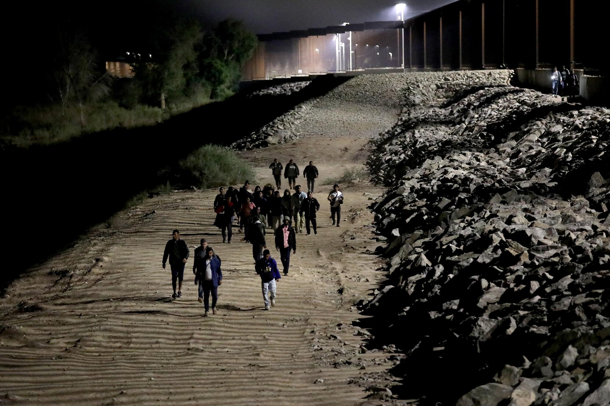 Immigrants turn themselves over to U.S Border Patrol agents along the U.S.-Mexico border in Somerton, Ariz., on May 11.