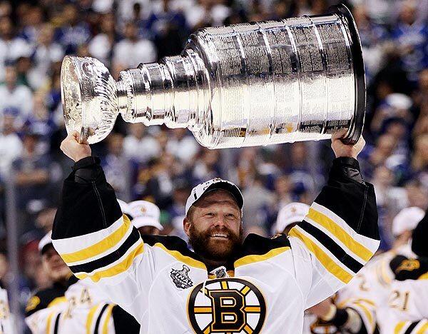 Boston goalie Tim Thomas holds the Stanley Cup following the Bruins' 4-0 victory over Vancouver in Game 7 of the Stanley Cup finals on Wednesday.