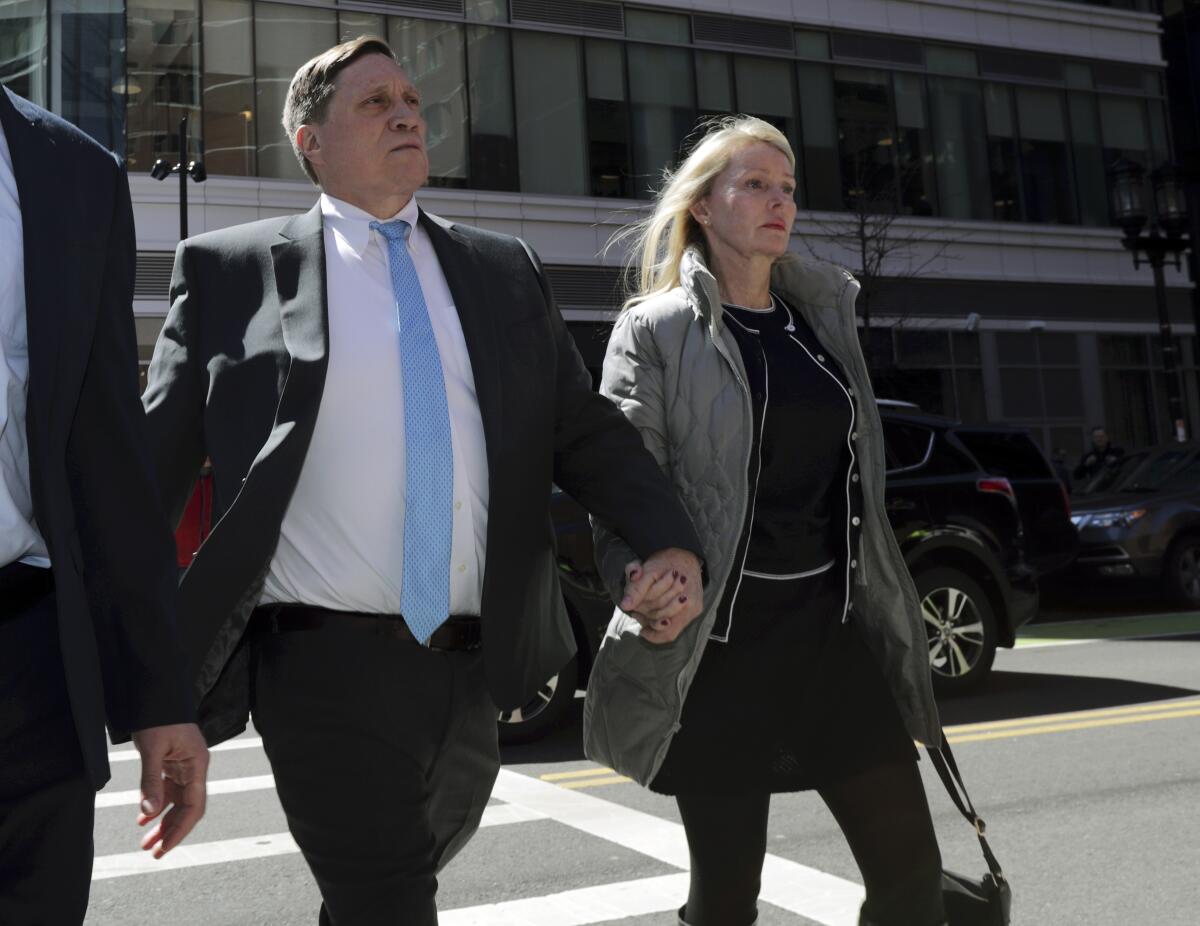 Investor John Wilson and his wife arriving at federal court in Boston