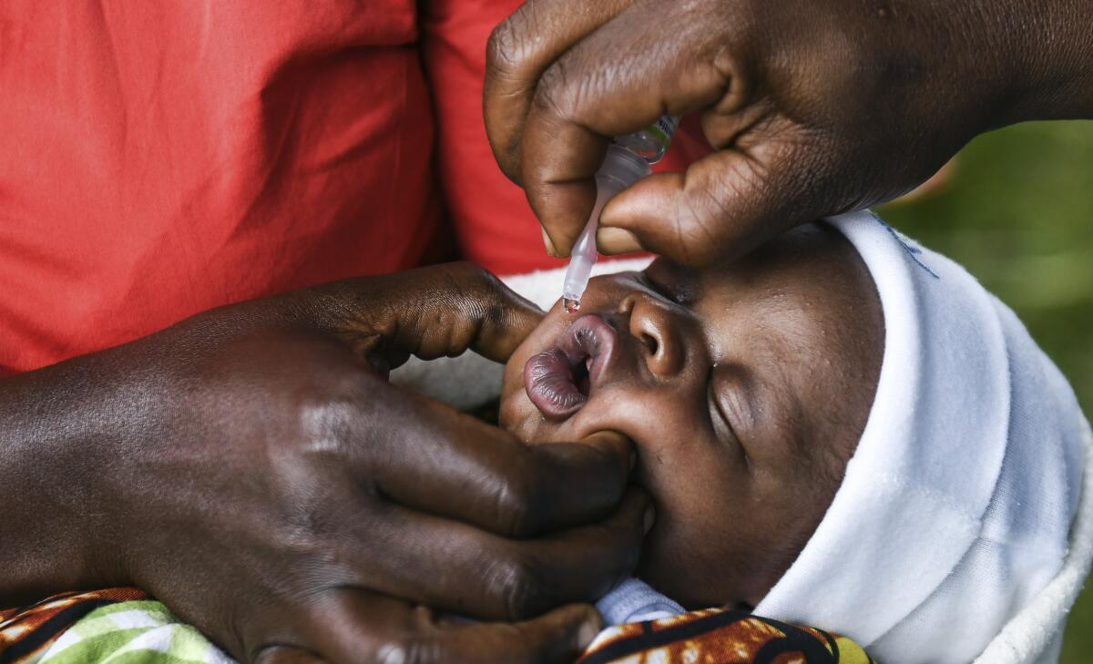 A baby receives an oral dose of polio vaccine during the Malawi Polio Vaccination Campaign Launch.