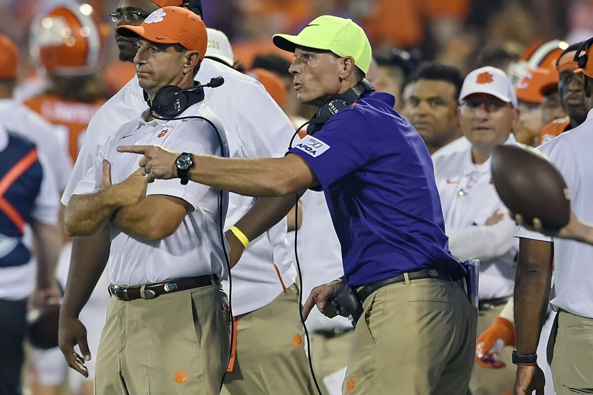 FILE - Clemson head coach Dabo Swinney, left, and defensive coach Brent Venables talk during an NCAA college football game against Georgia Tech, in Clemson, S.C., Thursday, Aug. 29, 2019. A person with knowledge of the situation tells The Associated Press that Oklahoma is targeting Clemson defensive coordinator Brent Venables to be its new head coach. (AP Photo/Richard Shiro, File)