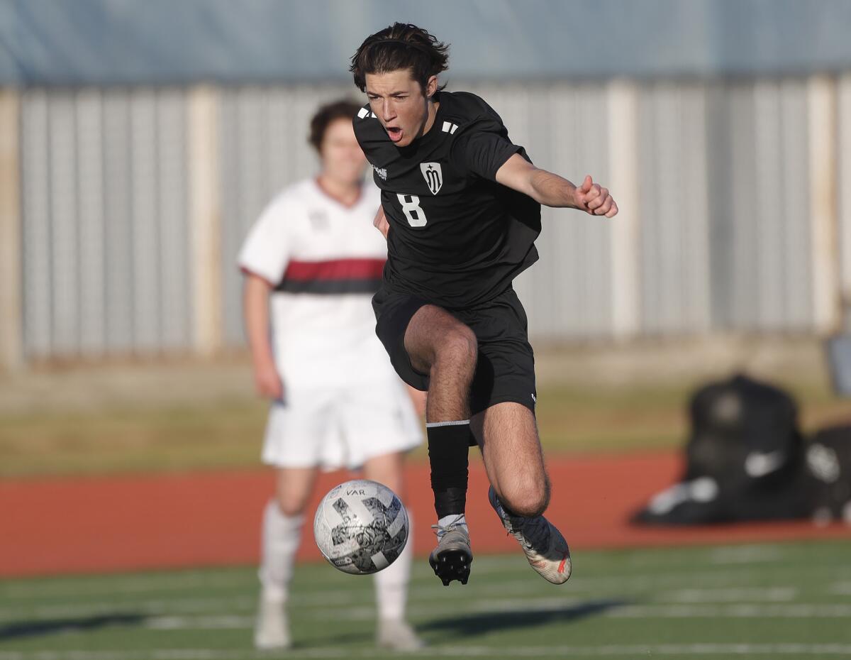 Marina's Ryan Spielman runs the ball up the field for a shot against Laguna Beach on Friday.