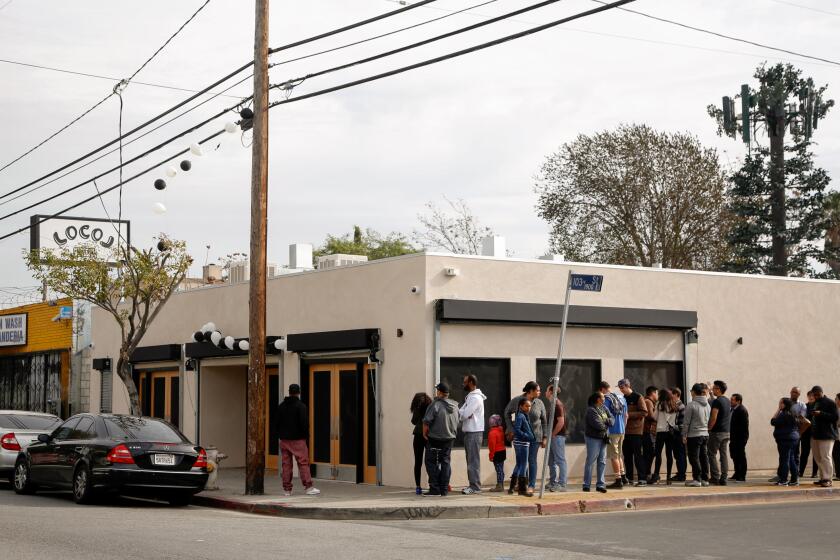 LOS ANGELES, CA - Jan. 19, 2016: A line goes out the door and around the building at Locol, the new fast food project that chef Roy Choi and chef Daniel Patterson have opened in Watts. (Photo by Katie Falkenberg / Los Angeles Times)