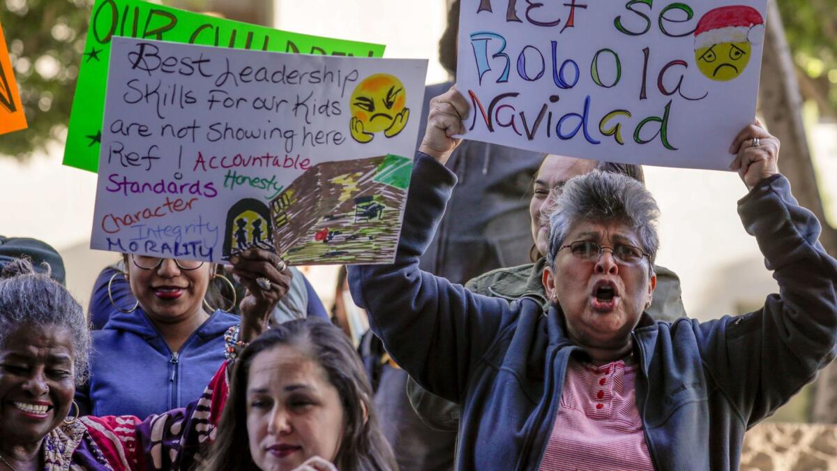 Suyapa Maldonado and other parents demonstrate outside the downtown L.A. Foltz Criminal Justice Center, calling on school board member Ref Rodriguez, who faces criminal charges, to resign.