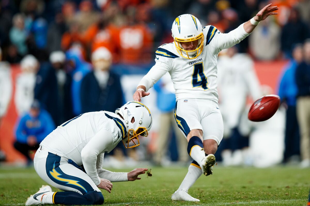 With Ty Long holding, the Chargers' Michael Badgley kicks a field goal last season against the Broncos in Denver.