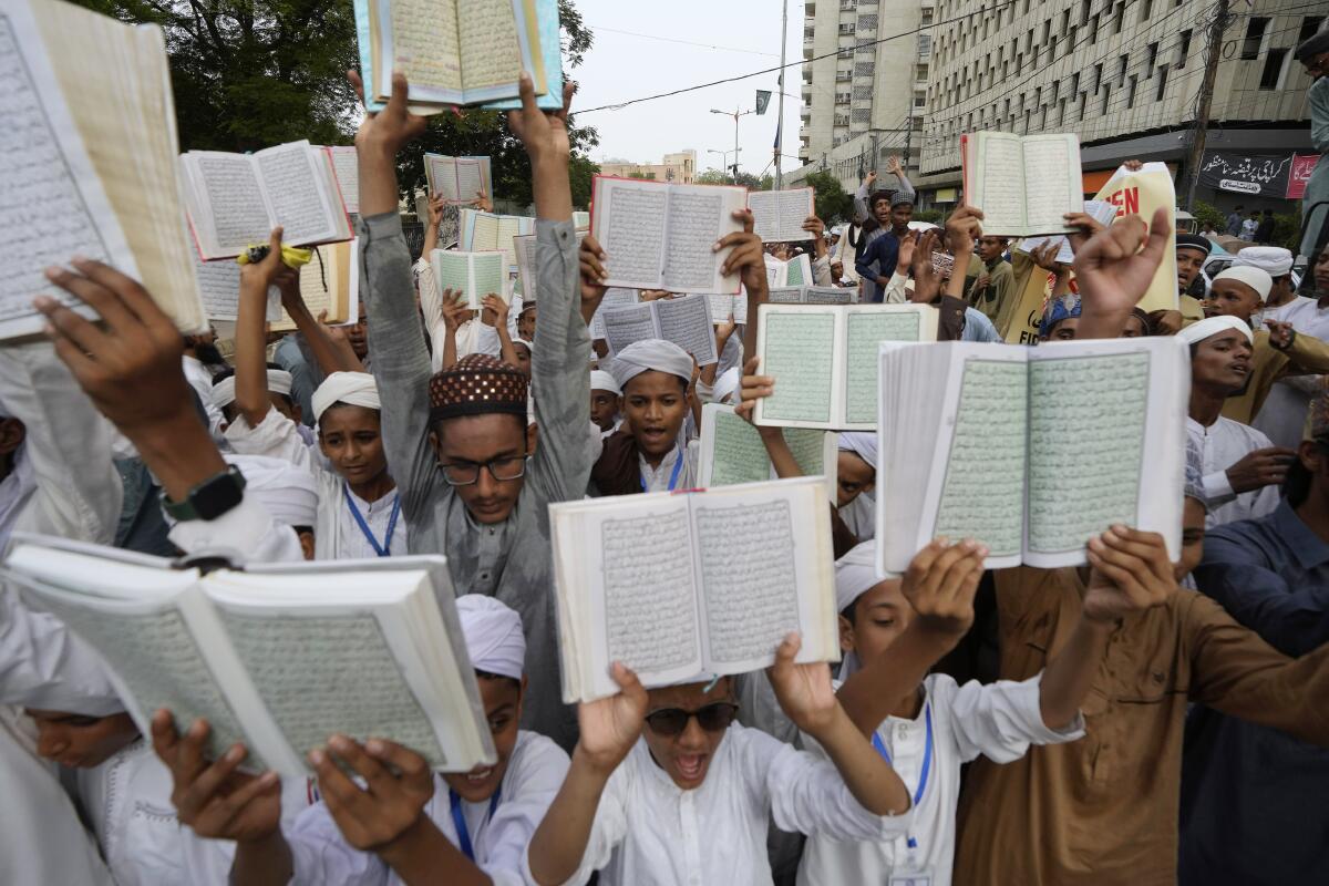 Children hold copies of Islam's holy book Quran during a demonstration