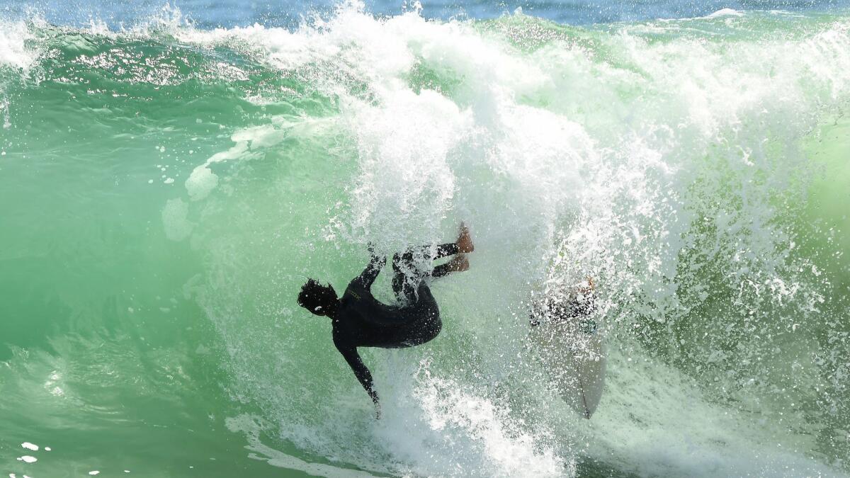 A surfer wipes out while riding a wave at the Wedge in Newport Beach.