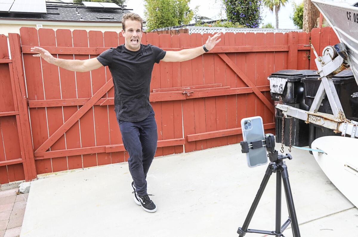 Kevin McClintock, a teacher at The Rock Academy, practices a dance challenge before posting it to his TikTok feed called "Mr. McTikTok" on Tuesday in San Diego, California. McClintock has amassed more that 86,000 followers and on video got 1.3 million views.