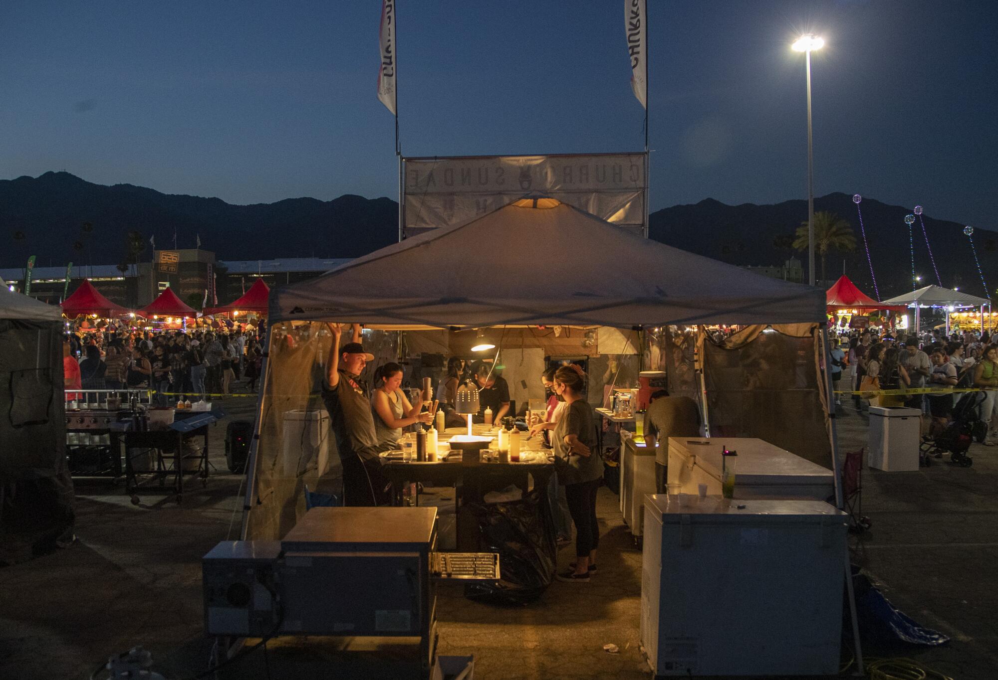 Vendors work inside a dessert stand at the 626 Night Market.