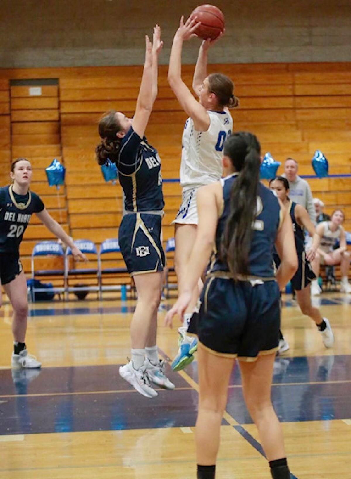 Abigail Lesagonicz aims for the basket in a Rancho Bernardo High vs. Del Norte High basketball game.