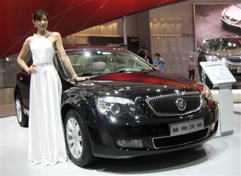 A Chinese model poses with a Buick's new Park Avenue luxury sedan at the 6th Guangzhou International Automobile Exhibition in Guangzhou, south China's Guangdong province, Tuesday, Nov. 18, 2008. GM, Ford, Toyota, Honda, Fiat,virtually all the big automakers turned out in force for the show in Guangzhou, capital of Guangdong, China's biggest single auto market with a population of nearly 95 million people. (AP Photo/William Foreman)