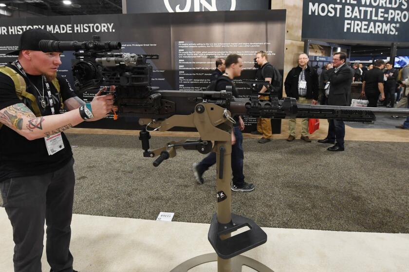 LAS VEGAS, NV - JANUARY 23: Mother of all Rucks Foundation member Kenneth Conkright of Colorado looks at a .50 caliber M2 machine gun equipped with a SOLO sight mount by Cadex at the 2018 National Shooting Sports Foundation's Shooting, Hunting, Outdoor Trade (SHOT) Show at the Sands Expo and Convention Center on January 23, 2018 in Las Vegas, Nevada. The SHOT Show, the world's largest annual trade show for shooting, hunting and law enforcement professionals, runs through January 26 and is expected to feature about 1,600 exhibitors showing off their latest products and services to more than 60,000 attendees. (Photo by Ethan Miller/Getty Images) ** OUTS - ELSENT, FPG, CM - OUTS * NM, PH, VA if sourced by CT, LA or MoD **