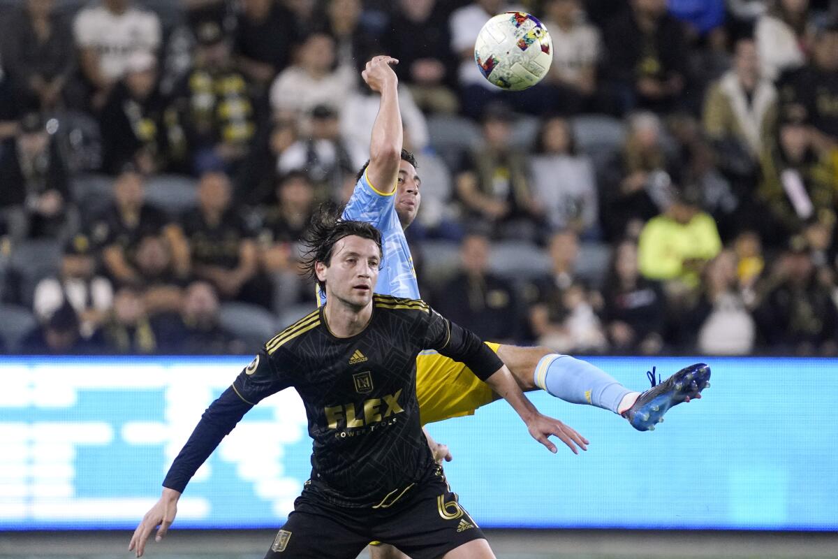 Philadelphia Union midfielder Alejandro Bedoya and LAFC midfielder Ilie Sánchez try to head the ball.