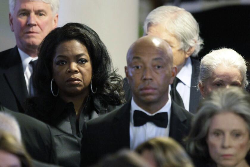 HYANNIS, MA - AUGUST 14: Oprah Winfrey (2nd L) and Russell Simmons (C) attend the funeral of Eunice Kennedy Shriver at St. Xavier Church August 14, 2009 in Hyannis, Massachusetts. Shriver, the fifth of nine children to Joseph P. Kennedy and Rose Kennedy, and the founder of the Special Olympics, died Tuesday after a series of strokes. (Photo by Steven Senne-Pool/Getty Images)