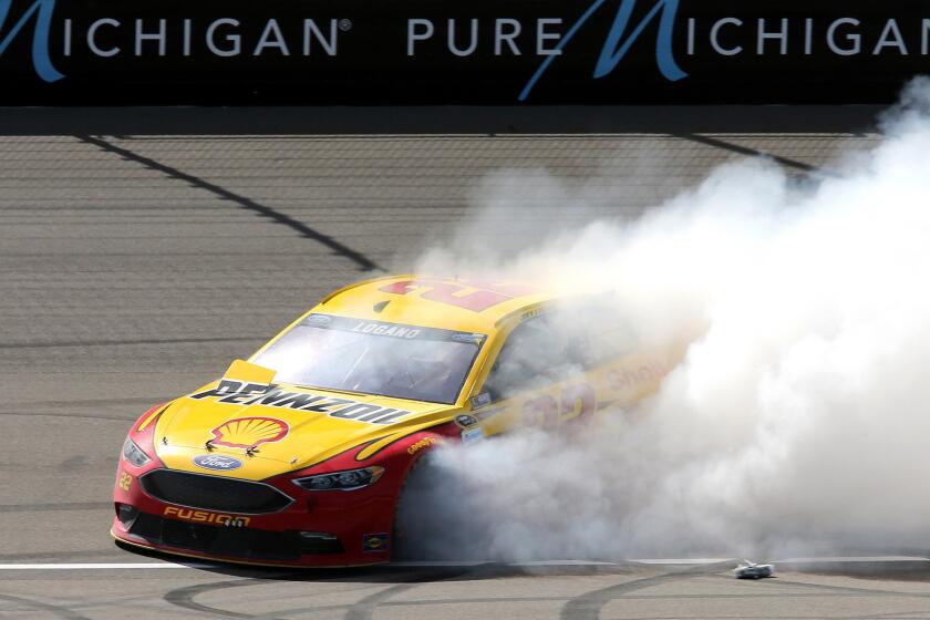 NASCAR driver Joey Logano does a burnout to celebrate his victory in the Sprint Cup Series at Michigan International Speedway on Sunday.
