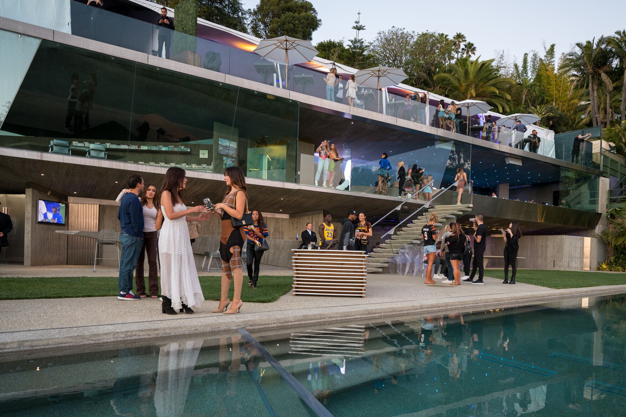 Party guests by the lap pool on Jimmy Goldstein's new terrace.