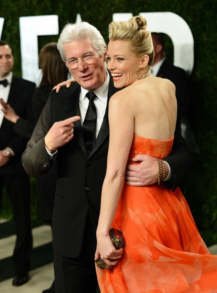 Richard Gere, left, and actress Elizabeth Banks share a moment on the way to the party