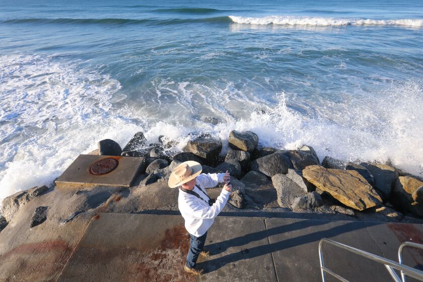 John Lovell of Oceanside captures the King Tide waves on his smartphone, at Buccaneer Beach, January 10, 2020 in Oceanside, California.