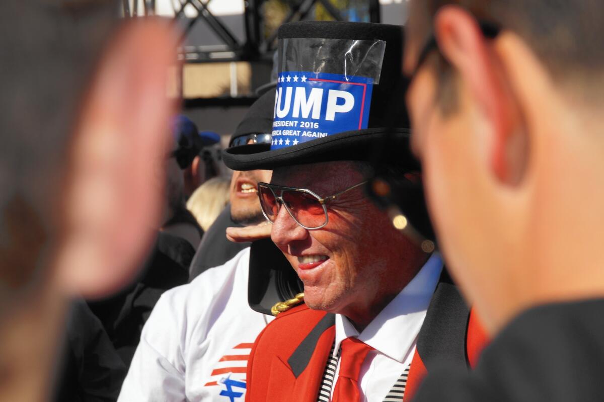 A Donald Trump supporter joins more than a thousand backers of the front-runner for the Republican presidential nomination in front of the Pacific Amphitheatre in Costa Mesa hours before Trump's scheduled appearance Thursday.