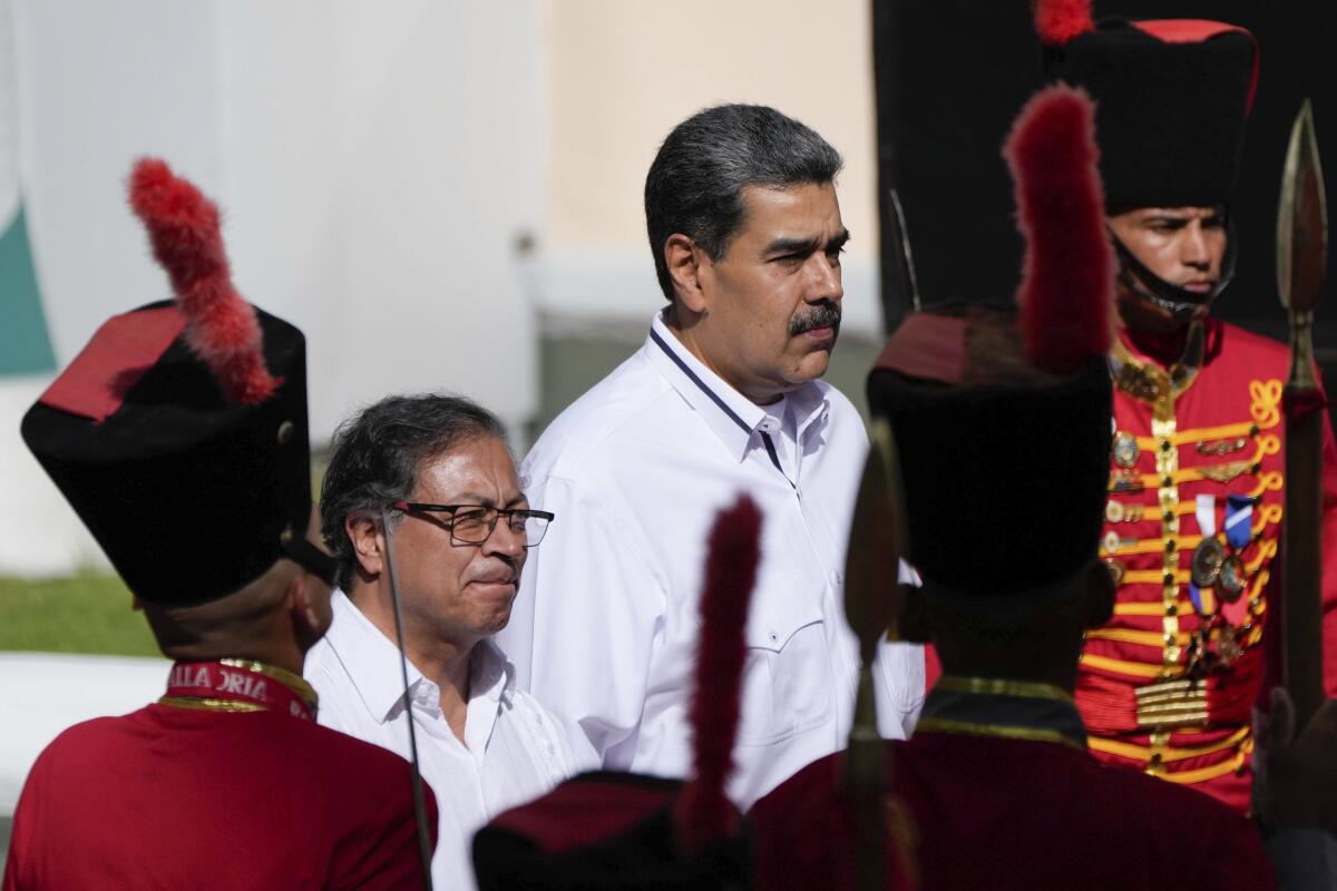 Venezuelan President Nicolas Maduro, right, stands with Colombian President Gustavo Petro.