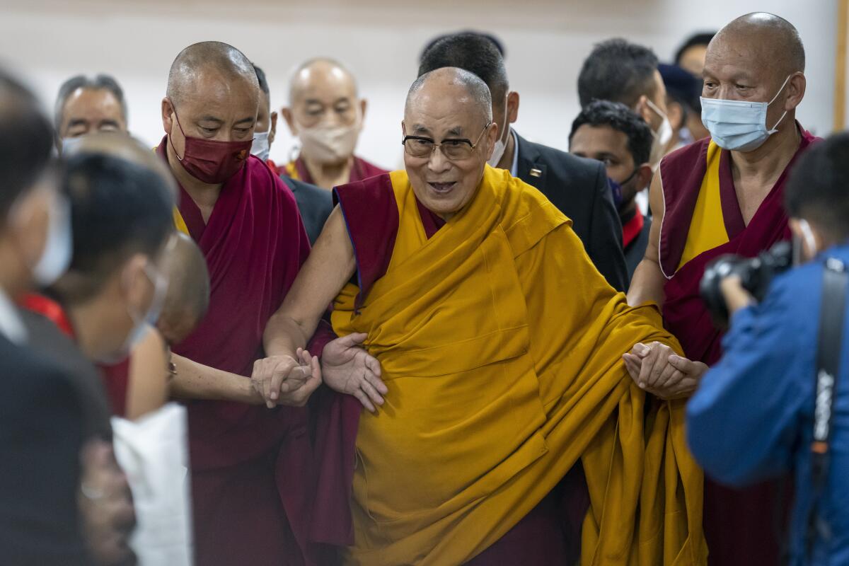 Dalai Lama flanked by Tibetan monks