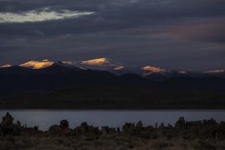LEE VINING, CA - October 26 2021: Snowcapped mountains north of Mono Lake are aglow with the last rays of the setting sun on Tuesday, Oct. 26, 2021 in Lee Vining, CA. Regulatory officials hope to coax the LADWP to reduce diversion of water from Mono Lake to help mitigate air pollution. (Brian van der Brug / Los Angeles Times)