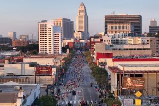 LOS ANGELES, CA- MARCH 17: The LA Marathon makes its way onto Broadway in Chinatown at the two-mile mark on Sunday, March 17, 2024. Over 25,000 runners competed this year. (Myung J. Chun / Los Angeles Times)