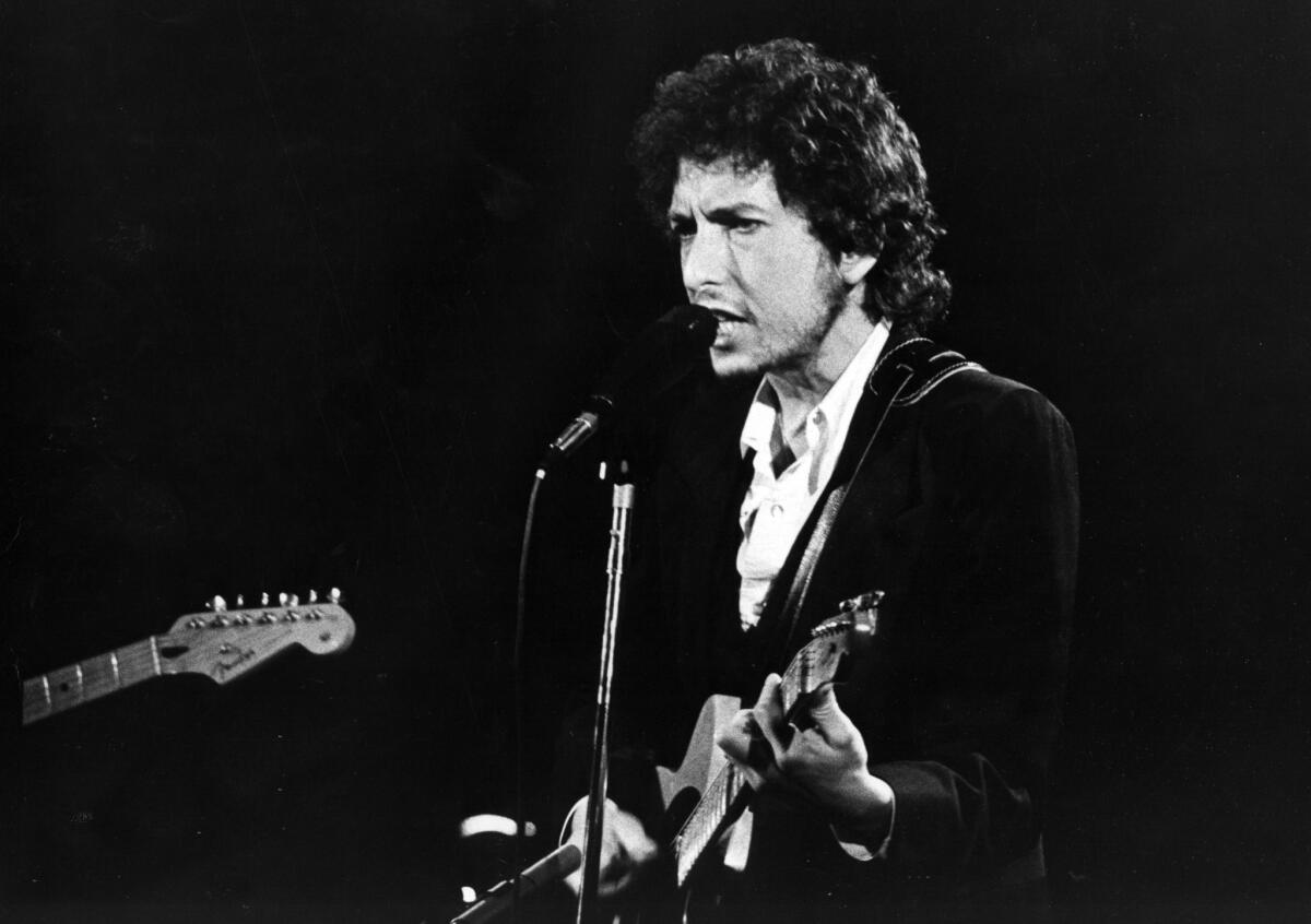 Bob Dylan is seen in concert at the Forum in Los Angeles on Feb. 15, 1974.