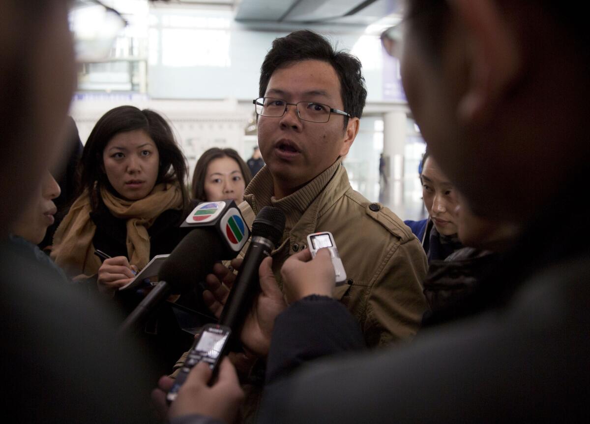 A Malaysian man who says he has relatives on board a missing Malaysia Airlines plane talks to journalists at Beijing's international airport.