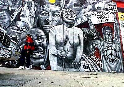 Noni Olabisi's mural commemorates the Los Angeles riots of 1992. The mural is on the side of a building at 1815 W. 54th Street