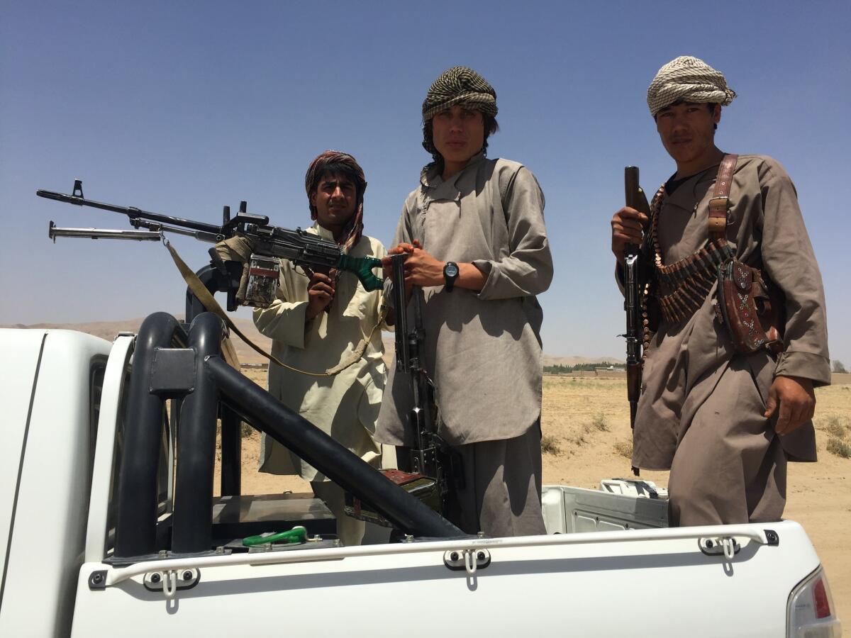 Afghan Local Police members leave for a battle in Eshkamesh, Afghanistan, in July.