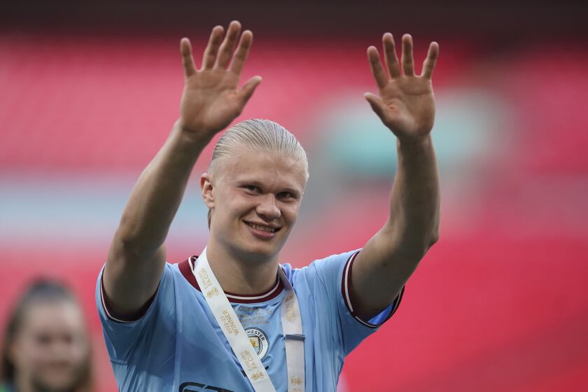 Manchester City's Erling Haaland applauds fans as he celebrates winning the English FA Cup final soccer match between Manchester City and Manchester United at Wembley Stadium in London, Saturday, June 3, 2023. Manchester City won 2-1. (AP Photo/Dave Thompson)
