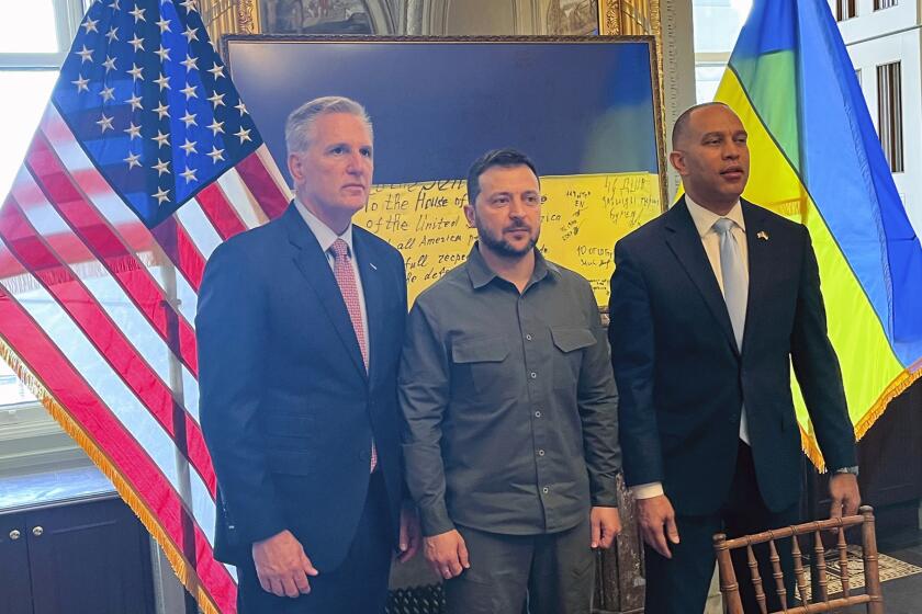 In this photo provided to the Associated Press, Ukrainian President Volodymyr Zelenskyy, center, poses for a photo with House Speaker Kevin McCarthy of Calif., left, and House Minority Leader Hakeem Jeffries of N.Y., at a closed-door meeting with members of Congress on Capitol Hill in Washington, Thursday, Sept. 21, 2023. (AP Photo)