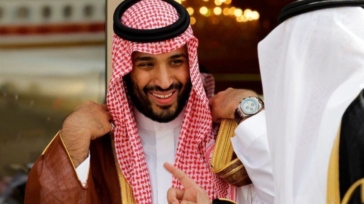 Mohammed bin Salman, left, smiles as he speaks with a fellow Saudi prince in Riyadh.