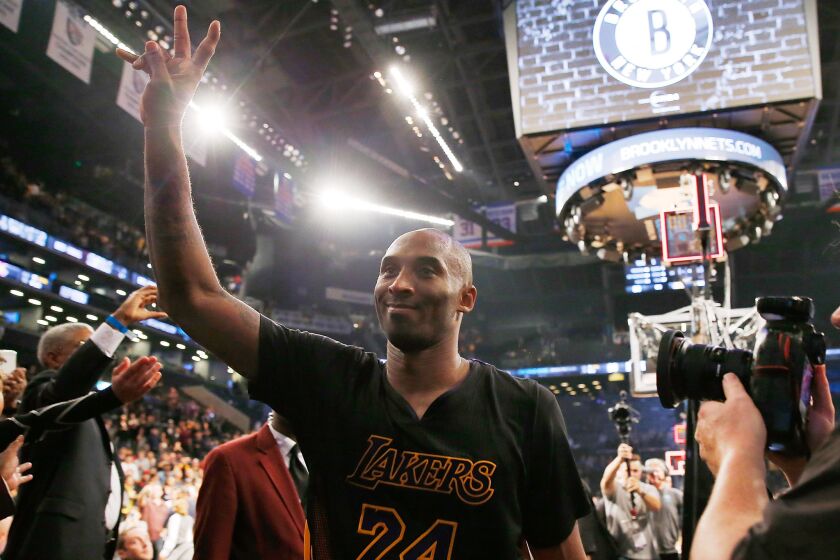 Kobe Bryant waves to the crowd after defeating the Brooklyn Nets, 104-98, at Barclays Center on Nov. 6.