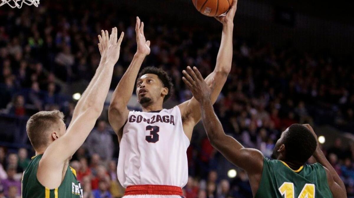 Gonzaga forward Johnathan Williams (3) shoots against San Francisco guard Charles Minlend (14) and center Jimbo Lull during the second half on Feb. 16.