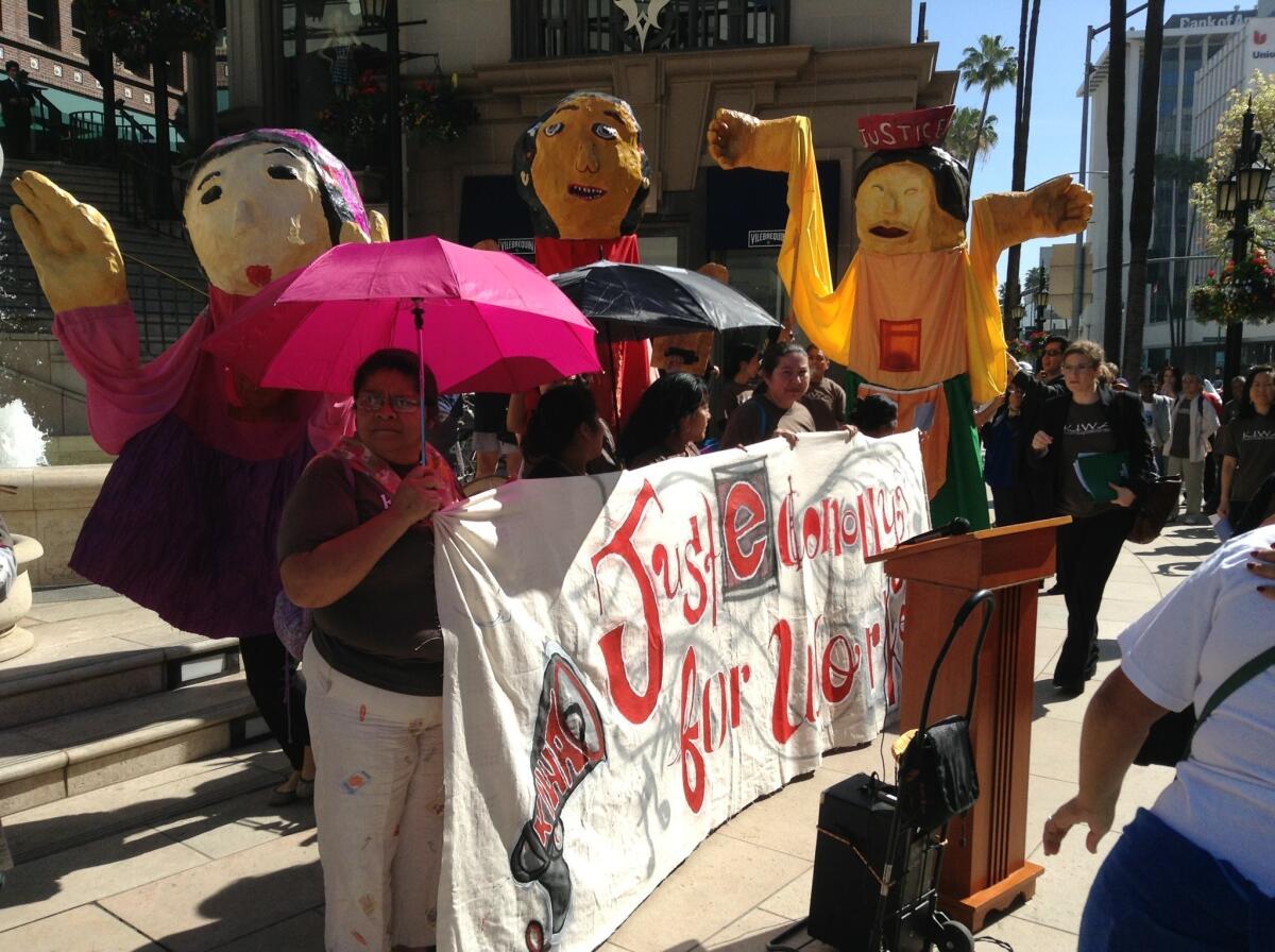 Protesters converge outside Urasawa on Rodeo Drive after the famed sushi restaurant was cited over labor violations.