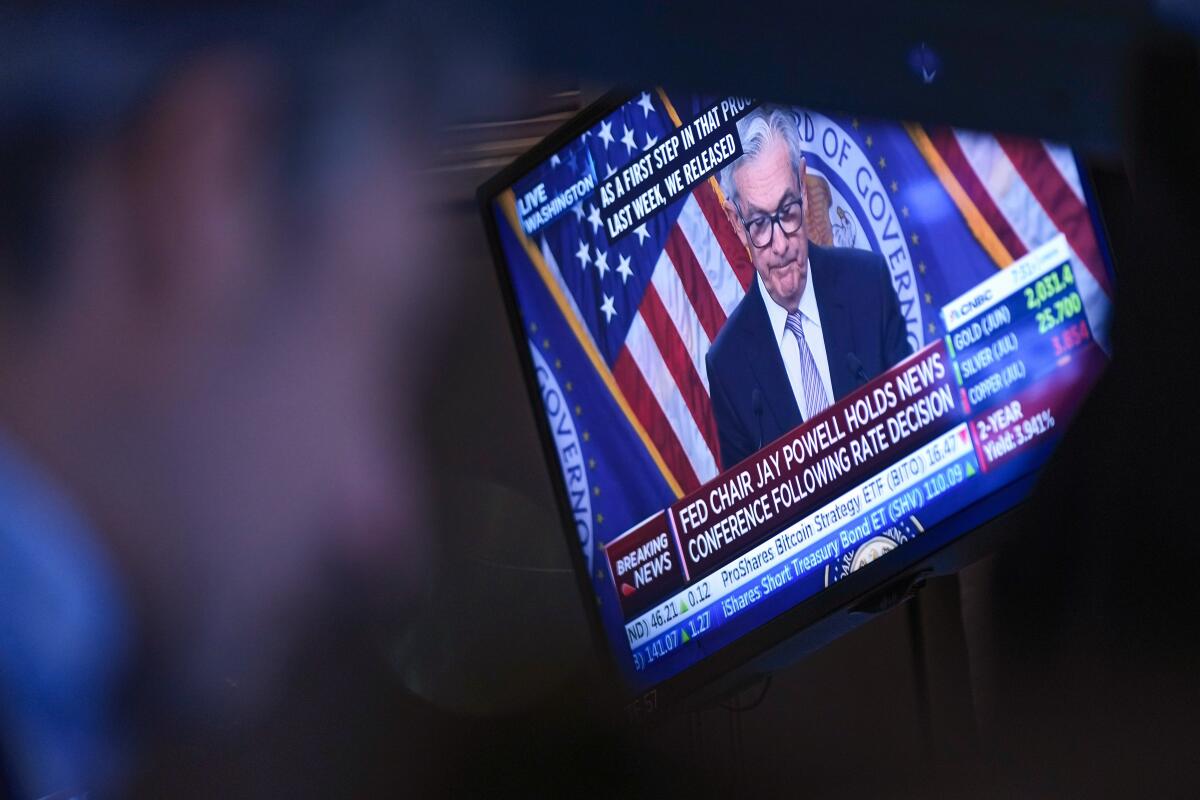 Federal Reserve Chairman Jerome Powell appears on a monitor at the New York Stock Exchange