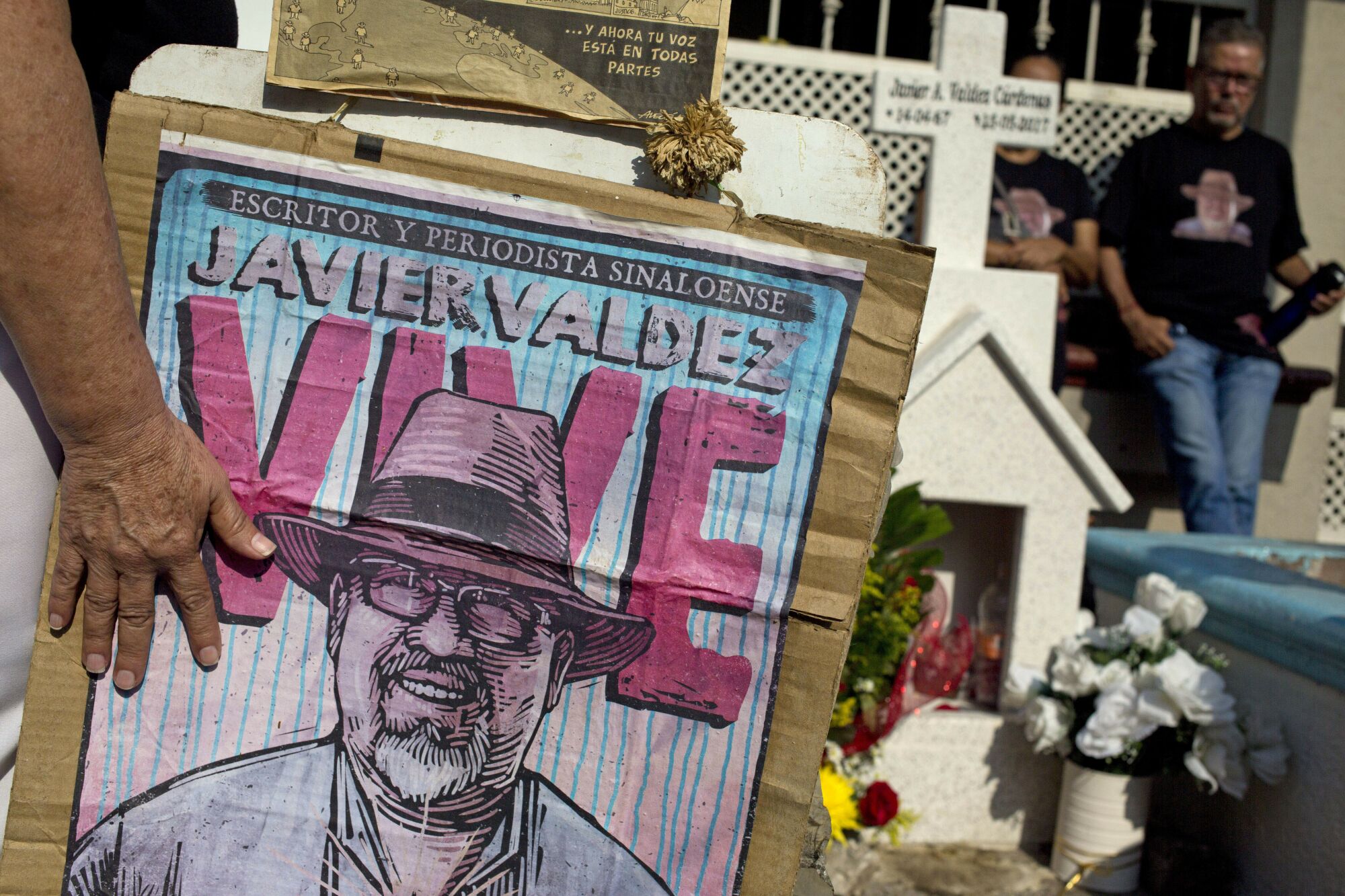 Relatives of slain journalist Javier Valdez, co-founder of Riodoce, stand at a memorial