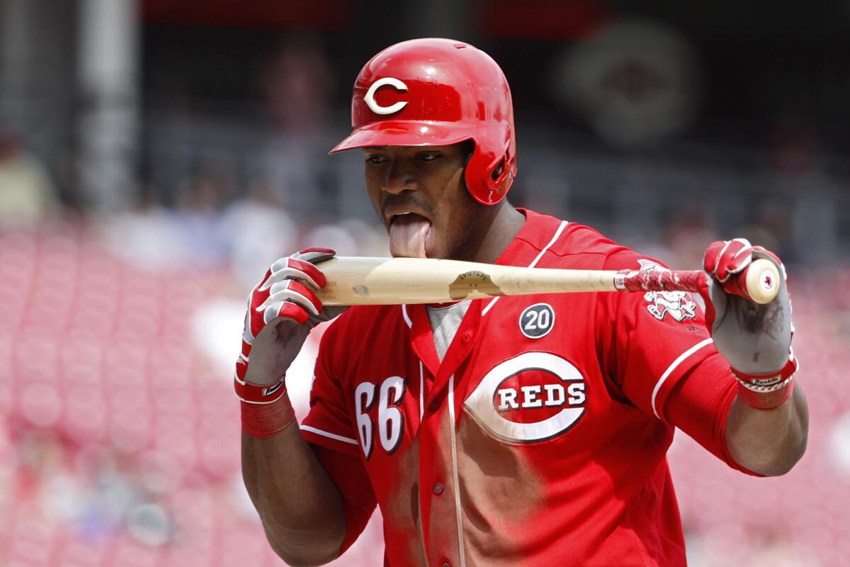 Yasiel Puig #66 of the Cincinnati Reds licks his bat after fouling off a pitch in the seventh inning against the Miami Marlins at Great American Ball Park on April 11, 2019 in Cincinnati, Ohio. The Reds won 5-0.