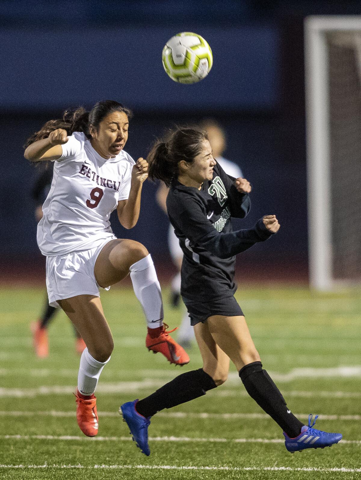 Costa Mesa's Vanessa Carrillo, right, goes up for a header against Estancia's Desiree Mendoza during an Orange Coast League match on Jan. 14.