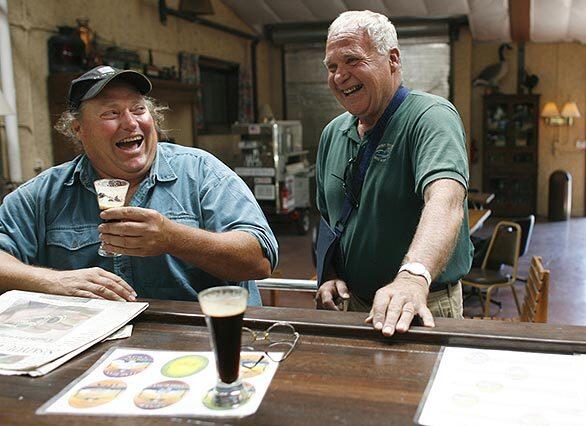 Vaune Dillmann, right, owner of Mt. Shasta Brewing Co., jokes with Bob Kunis in the brewery's tasting room in Weed, Calif. Kunis, from Breed, Wisc., was visiting his friend Andy Miles, who lives in Redding. Kunis and Miles stopped by after spending the day exploring the area around Weed. "It's just good-quality beer," said Miles, who had been to the brewery before.