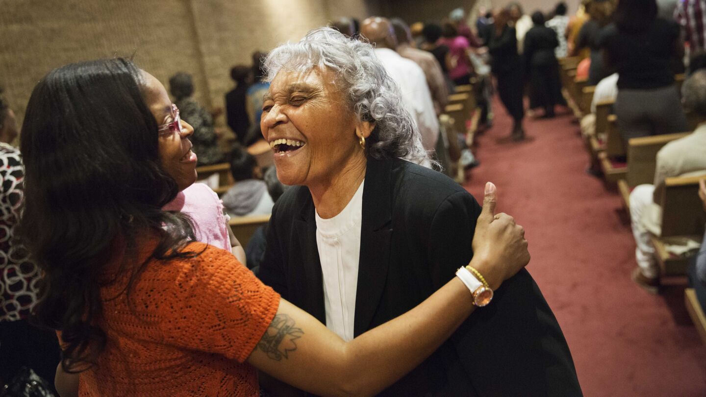 LaToyia Glover, left, embraces Hughetta Whitaker during a service at Southern Baptist Church on Sunday in Baltimore. A nearby senior center being built by the church was burned during the riots following Freddie Gray's funeral.